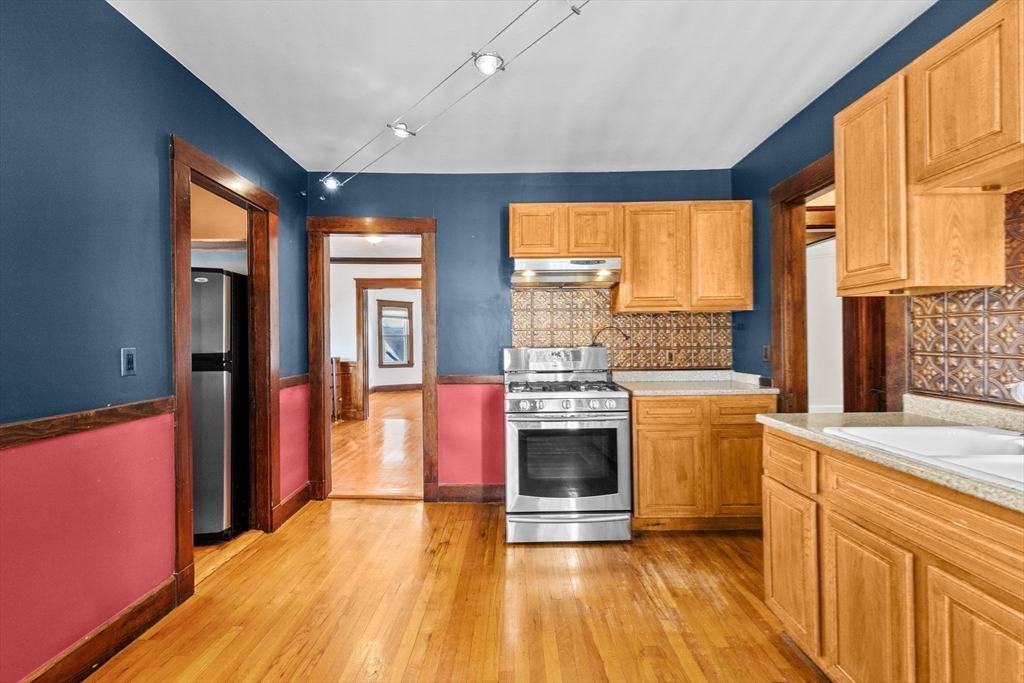 25 Whitby Terrace, Unit 3 Boston, MA 02125 - Photo 14 of 35 a kitchen with stainless steel appliances granite countertop a stove and a refrigerator