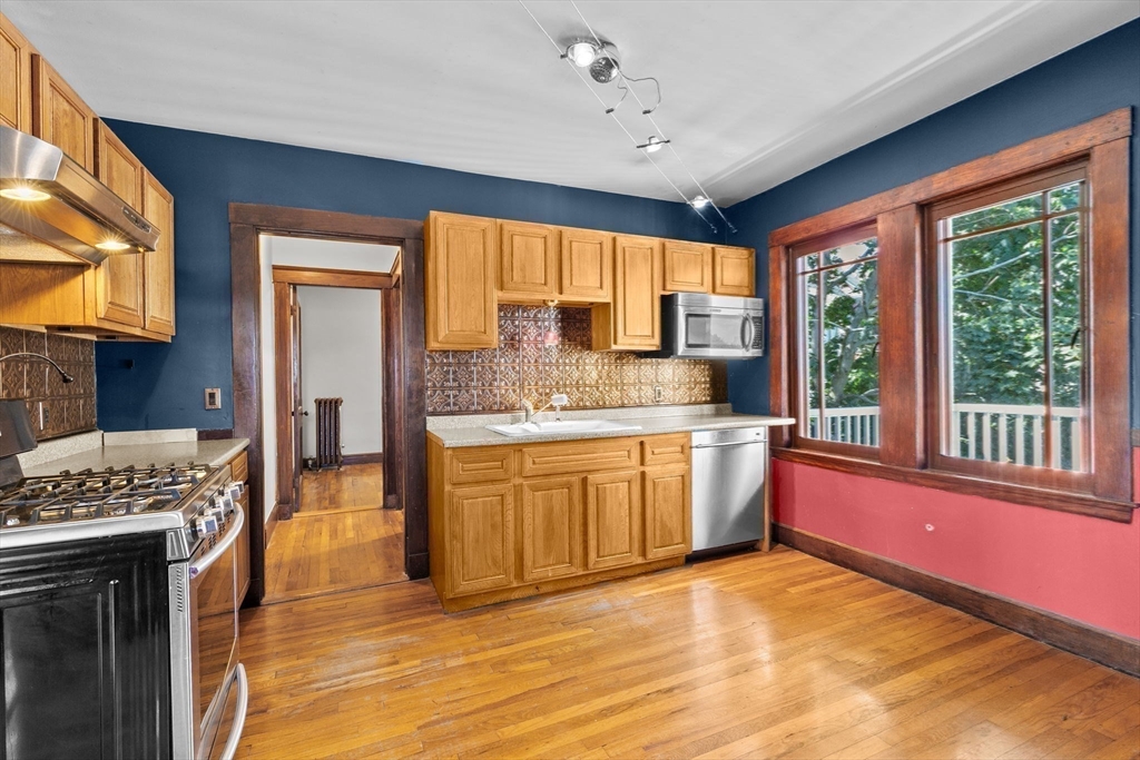 25 Whitby Terrace, Unit 3 Boston, MA 02125 - Photo 15 of 35 a kitchen with granite countertop a stove a sink and a refrigerator
