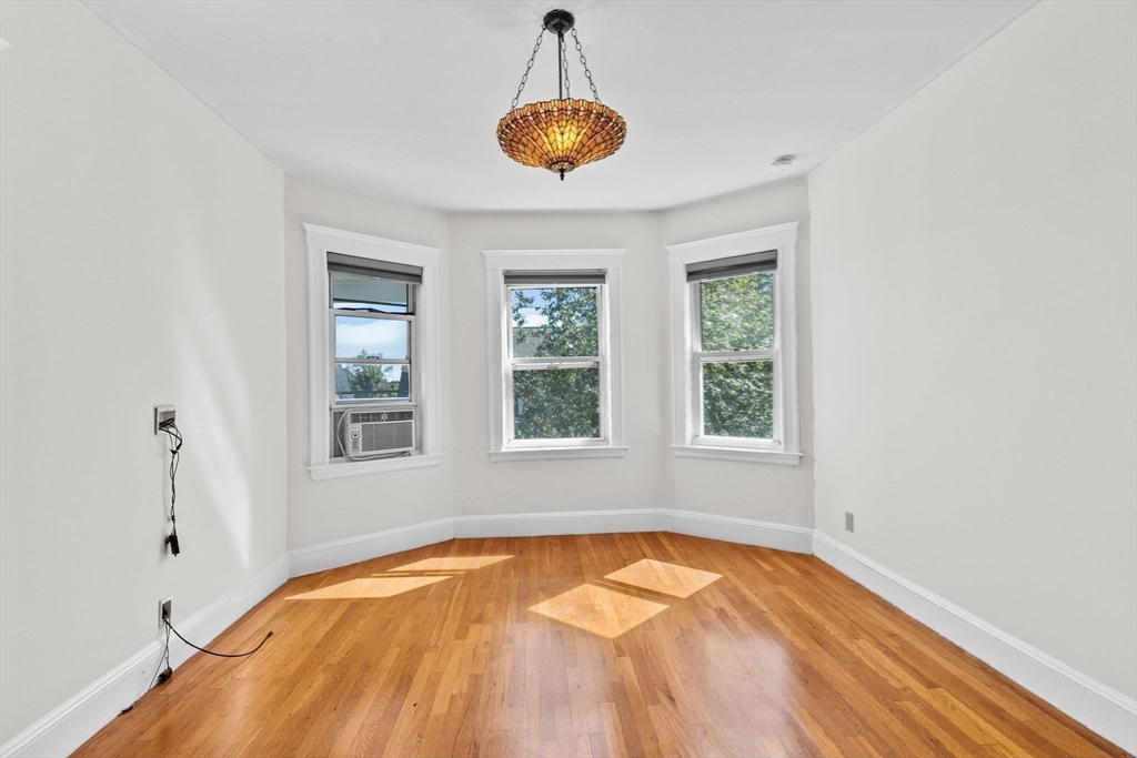 25 Whitby Terrace, Unit 3 Boston, MA 02125 - Photo 21 of 35 a view of empty room with wooden floor and windows