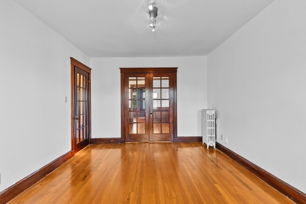 25 Whitby Terrace, Unit 3 Boston, MA 02125 - Photo 5 of 35 an empty room with wooden floor and windows