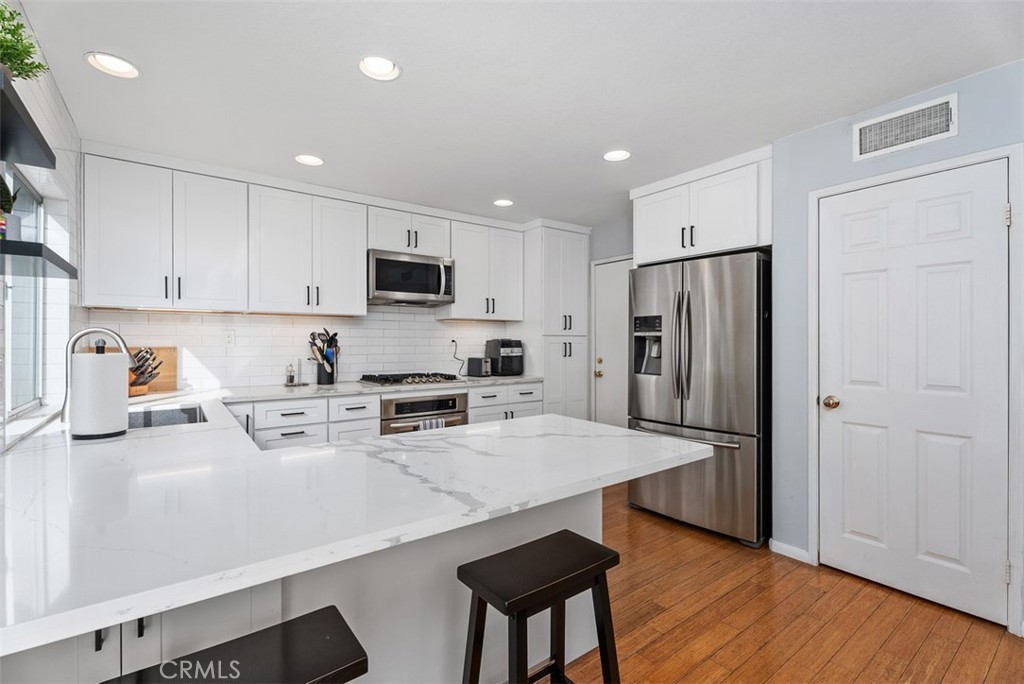 26 Richemont Way Aliso Viejo, CA 92656 - Photo 13 of 33 a kitchen with stainless steel appliances a refrigerator sink and microwave