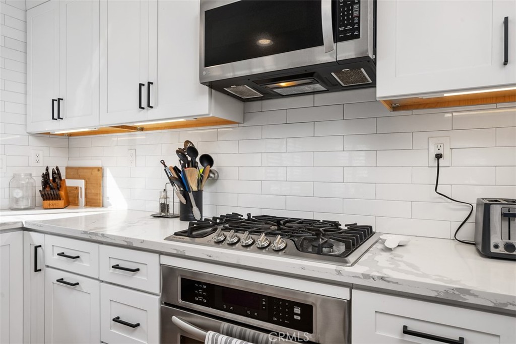 26 Richemont Way Aliso Viejo, CA 92656 - Photo 14 of 33 a white stove top oven sitting inside of a kitchen