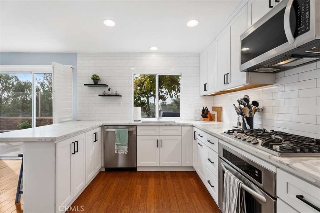 26 Richemont Way Aliso Viejo, CA 92656 - Photo 15 of 33 a kitchen with a stove a sink and a microwave