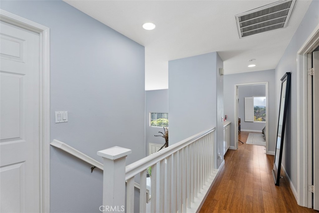 26 Richemont Way Aliso Viejo, CA 92656 - Photo 19 of 33 a view of a hallway with wooden floor and staircase
