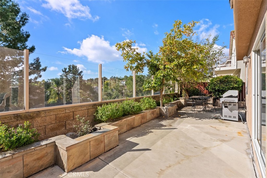 26 Richemont Way Aliso Viejo, CA 92656 - Photo 33 of 33 a view of a patio with a table and chairs and potted plants