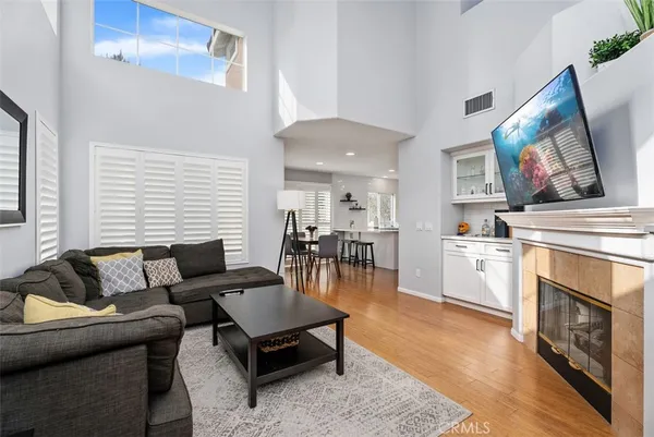 a living room with furniture a fireplace and a flat screen tv