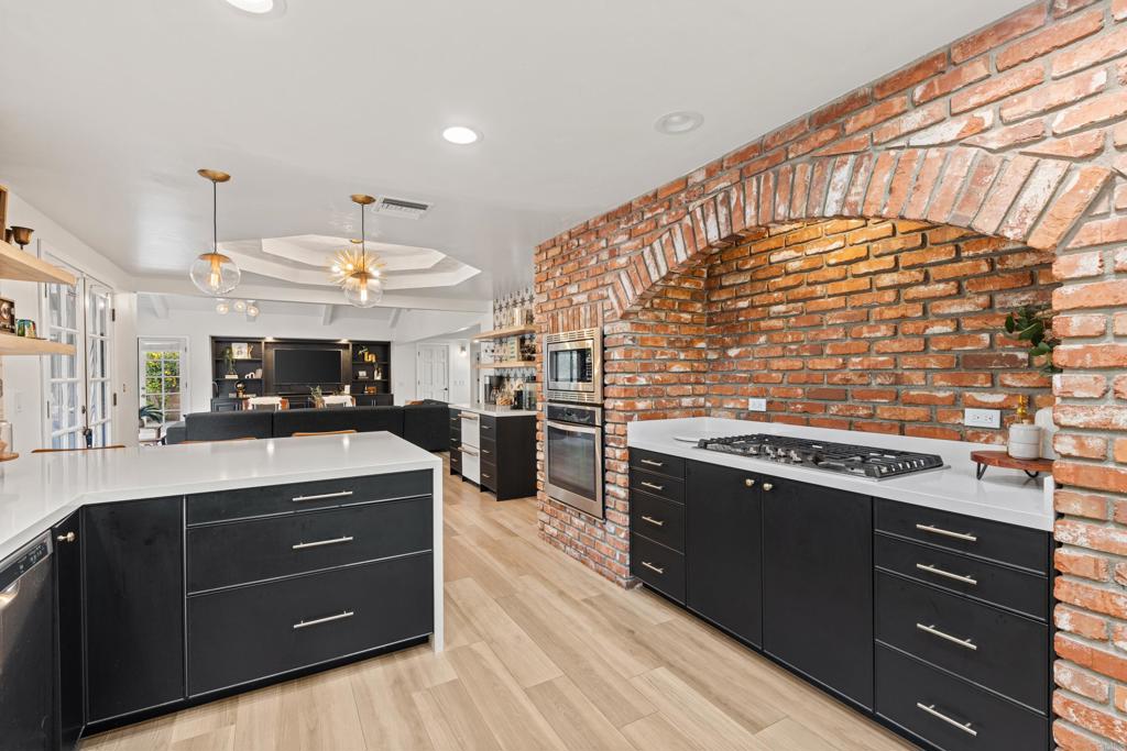 1637 Kings Way Vista, CA 92084 - Photo 11 of 39 a kitchen with stainless steel appliances granite countertop a stove and a sink