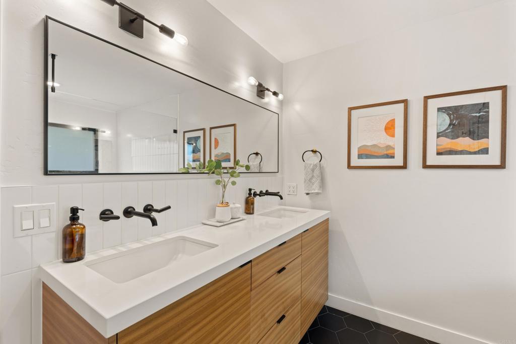 1637 Kings Way Vista, CA 92084 - Photo 19 of 39 a bathroom with a sink and a mirror