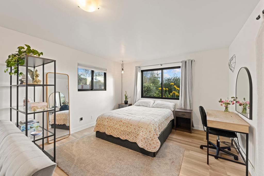 1637 Kings Way Vista, CA 92084 - Photo 20 of 39 a bedroom with a bed a table and chair