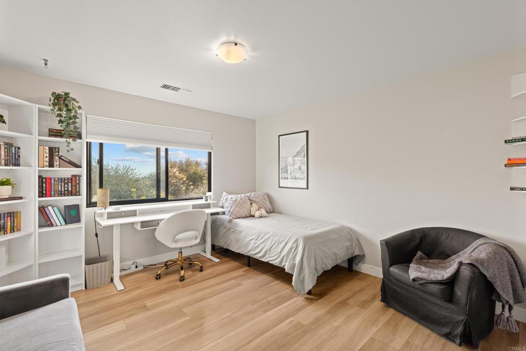 1637 Kings Way Vista, CA 92084 - Photo 23 of 39 a room with a bed a large window and couch