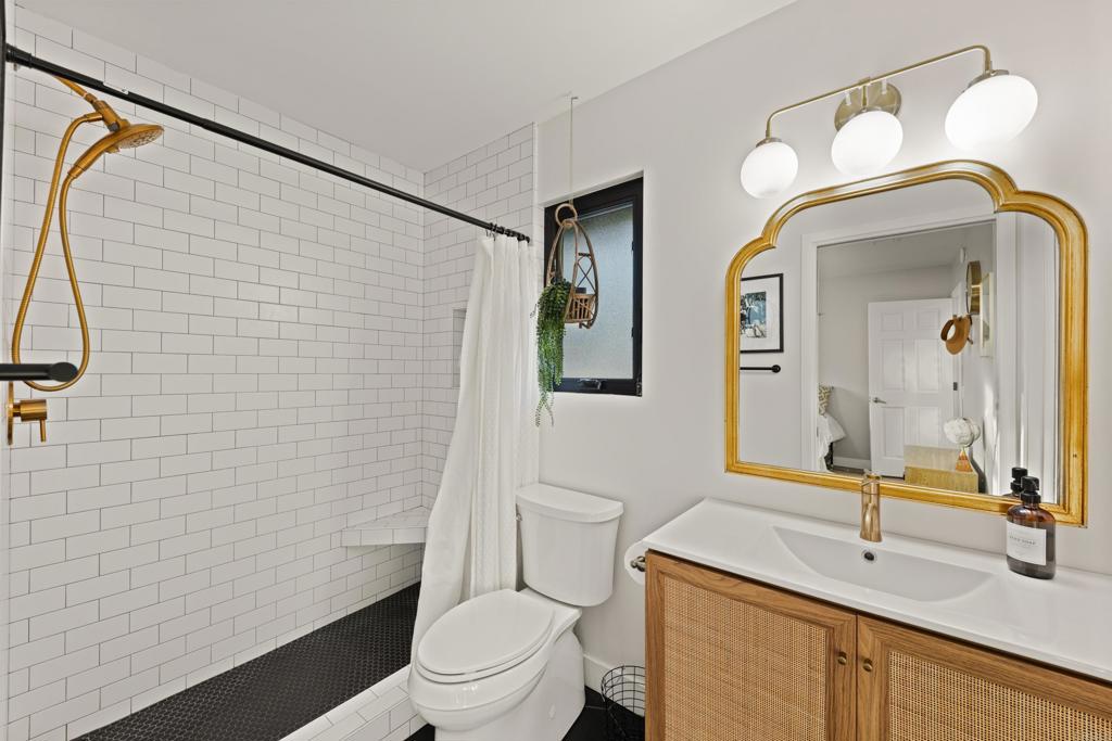 1637 Kings Way Vista, CA 92084 - Photo 24 of 39 a bathroom with a toilet sink vanity and mirror