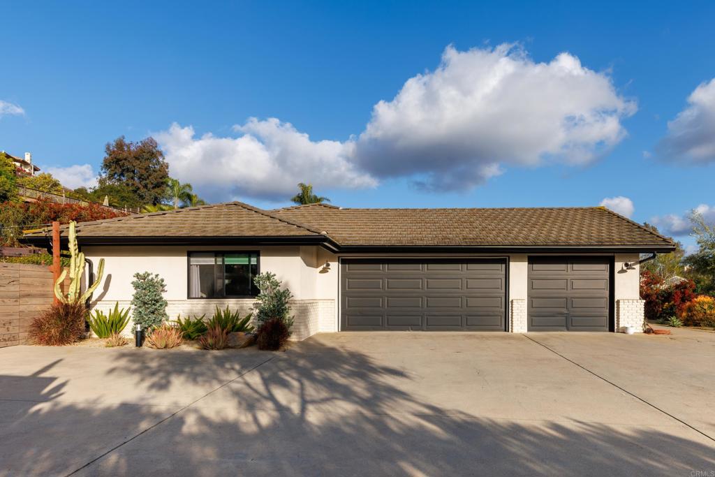1637 Kings Way Vista, CA 92084 - Photo 35 of 39 a front view of a house with a yard and garage
