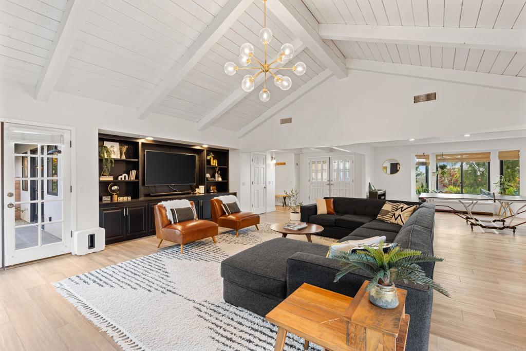 1637 Kings Way Vista, CA 92084 - Photo 9 of 39 a living room with furniture a flat screen tv and kitchen view