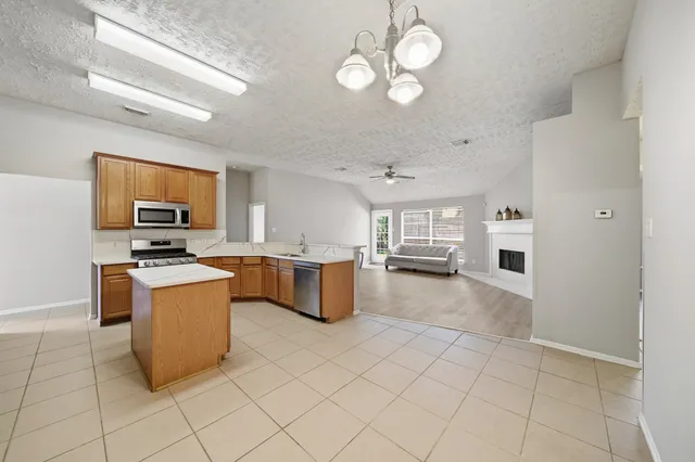 a view of a kitchen with a sink and stainless steel appliances