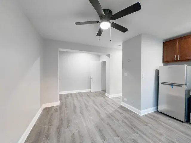 a view of a kitchen with a sink and a refrigerator