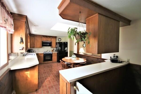 140 Old County Road Lancaster, MA 01523 - Photo 11 of 39 a dining room with furniture and a kitchen