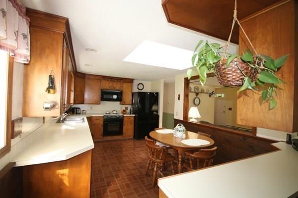 140 Old County Road Lancaster, MA 01523 - Photo 12 of 39 a kitchen with a table and chairs