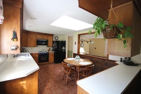140 Old County Road Lancaster, MA 01523 - Photo 14 of 39 a kitchen with a table chairs stove and refrigerator