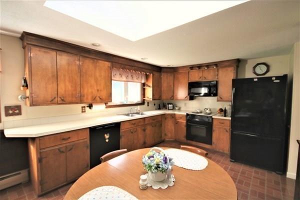 140 Old County Road Lancaster, MA 01523 - Photo 15 of 39 a kitchen with a refrigerator and a sink
