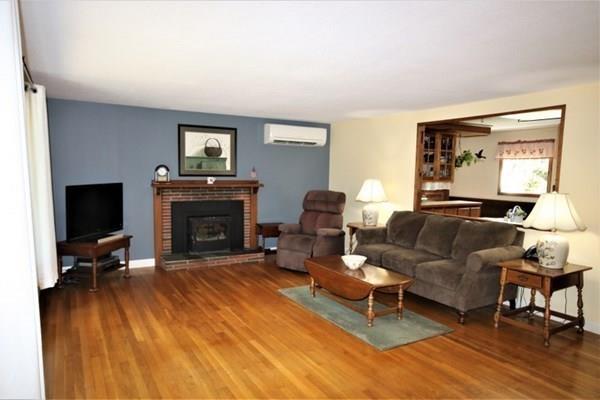 140 Old County Road Lancaster, MA 01523 - Photo 2 of 39 a living room with furniture and a fireplace