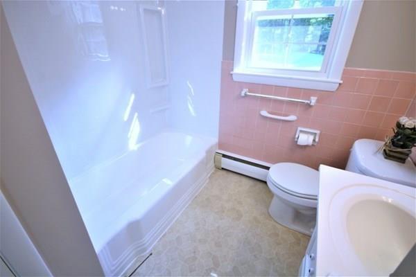 140 Old County Road Lancaster, MA 01523 - Photo 25 of 39 a bathroom with a sink a toilet and a window