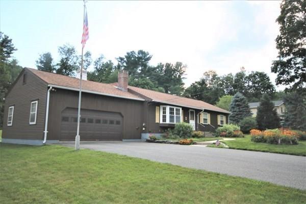 140 Old County Road Lancaster, MA 01523 - Photo 31 of 39 a front view of a house with a garden and plants