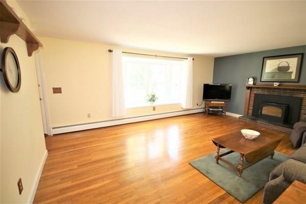 140 Old County Road Lancaster, MA 01523 - Photo 9 of 39 a living room with furniture a flat screen tv and a fireplace