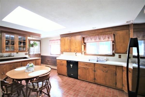 140 Old County Road Lancaster, MA 01523 - Photo 10 of 39 a large kitchen with a table and chairs
