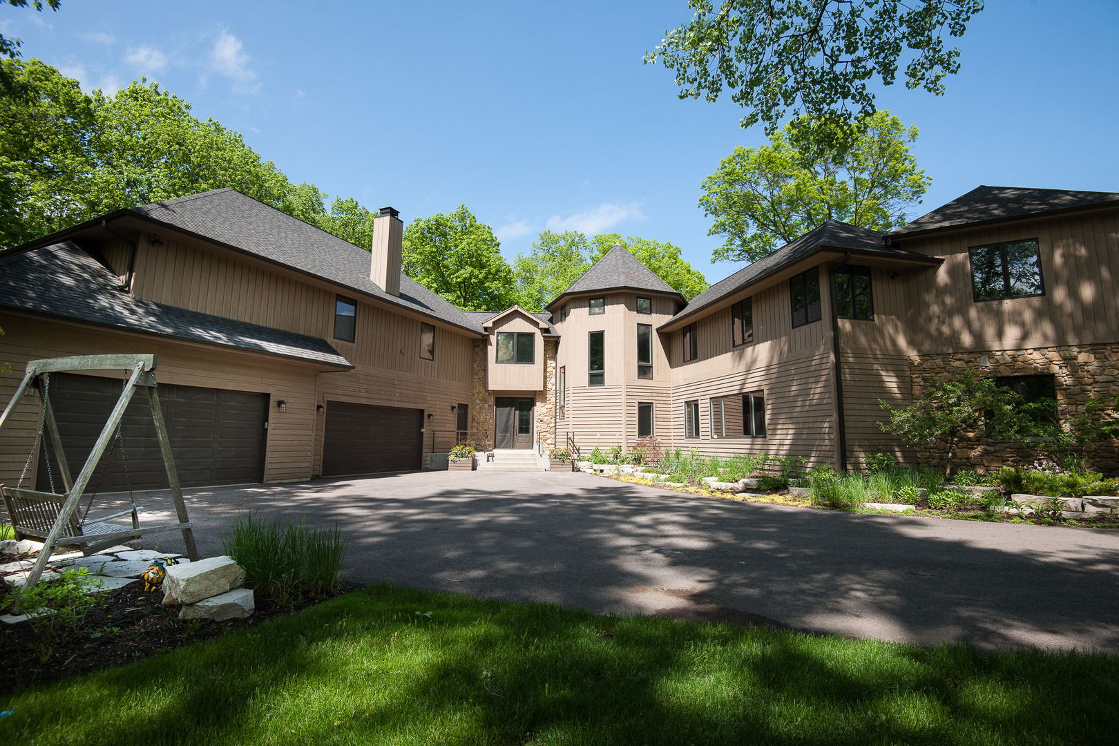 a front view of a house with a garden