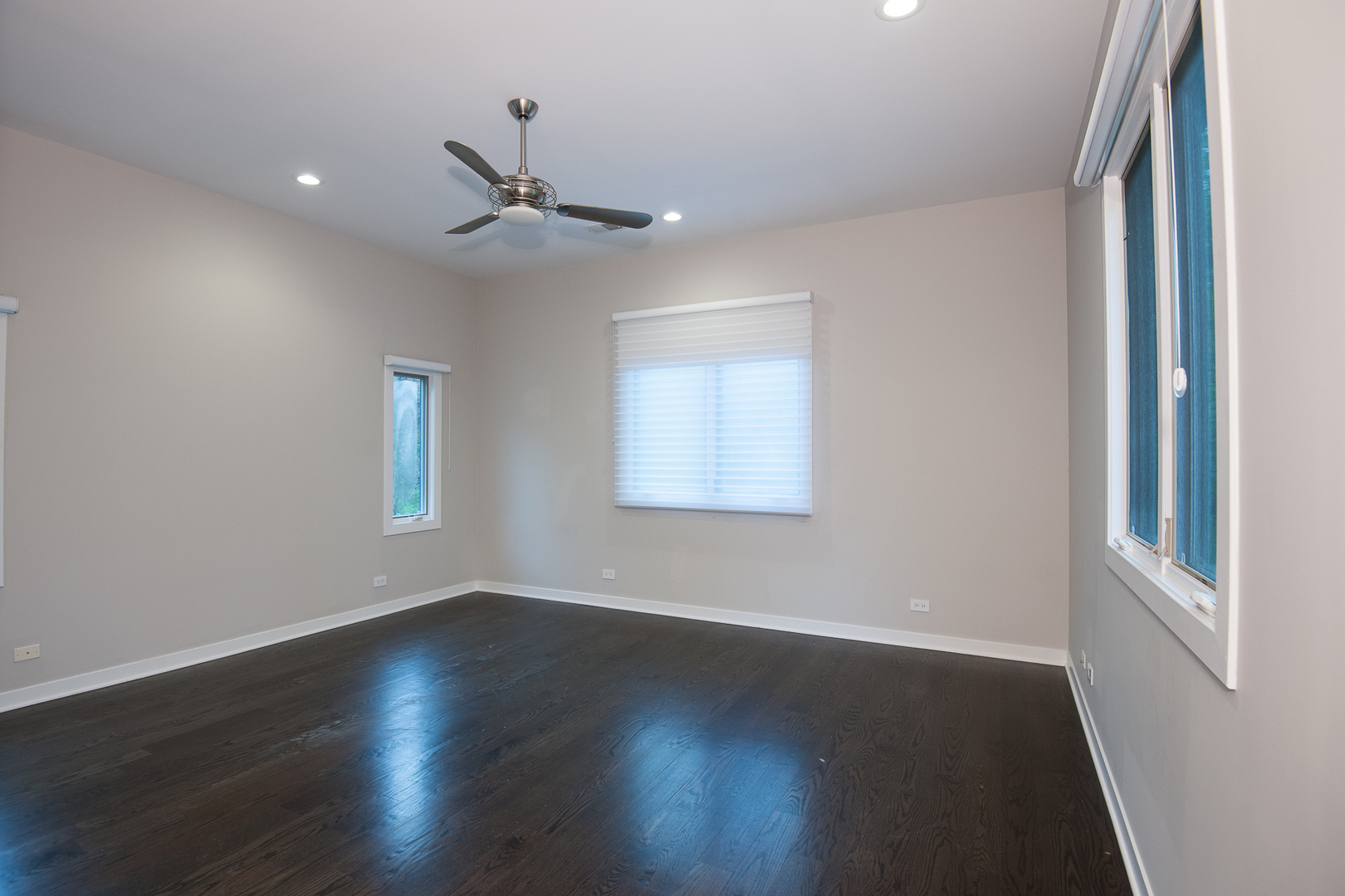Undisclosed Address Riverwoods, IL 60015 - Photo 21 of 33 an empty room with wooden floor ceiling fan and windows