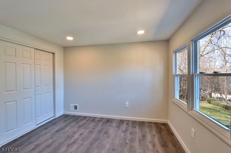 75 Nolans Point Road Lake Hopatcong, NJ 07849 - Photo 23 of 48 an empty room with wooden floor and windows