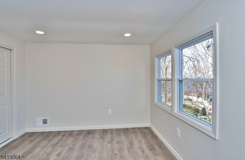 75 Nolans Point Road Lake Hopatcong, NJ 07849 - Photo 26 of 48 an empty room with wooden floor and windows