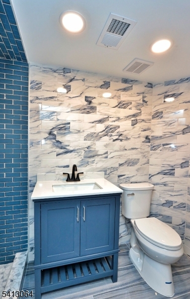 75 Nolans Point Road Lake Hopatcong, NJ 07849 - Photo 31 of 48 a bathroom with a sink a toilet and vanity