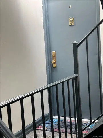 a view of staircase with railing and white walls