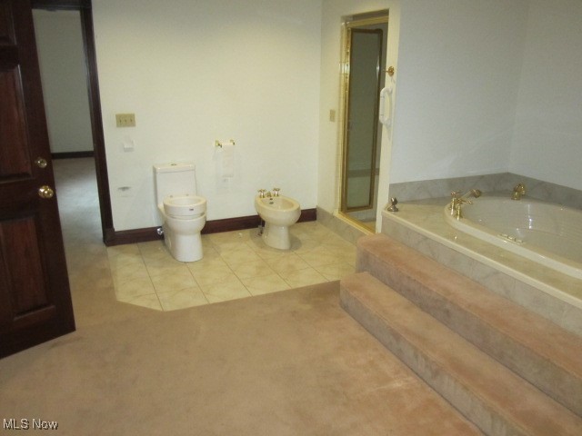 6999 Gates Road Gates Mills, OH 44040 - Photo 14 of 20 Full bathroom with a bidet, a bath, light tile patterned floors, and light colored carpet