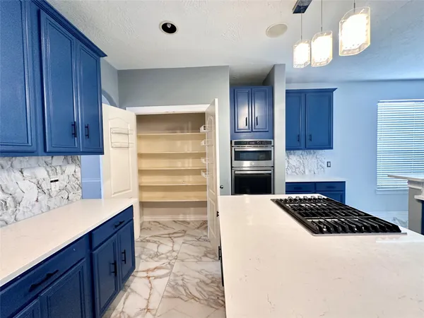 a kitchen with a refrigerator and a stove
