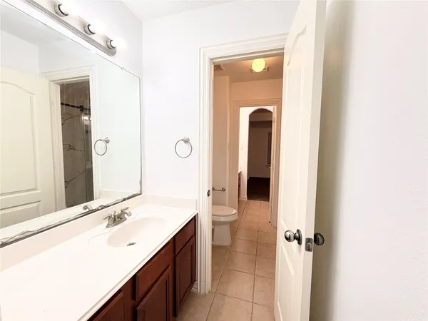 a bathroom with a double vanity sink and mirror