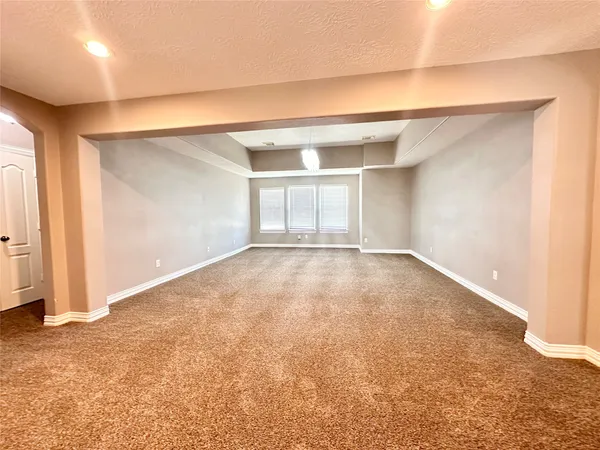 an empty room with a empty space and windows