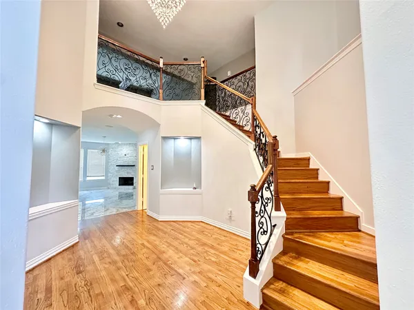 a view of entryway and hall with wooden floor