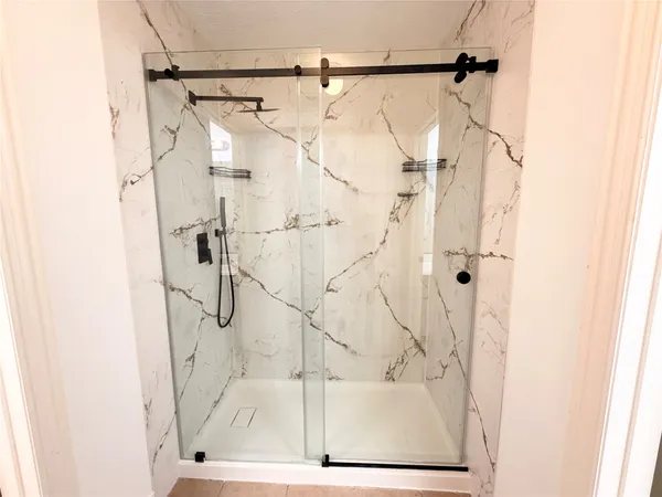 a bathroom with a shower and a shower