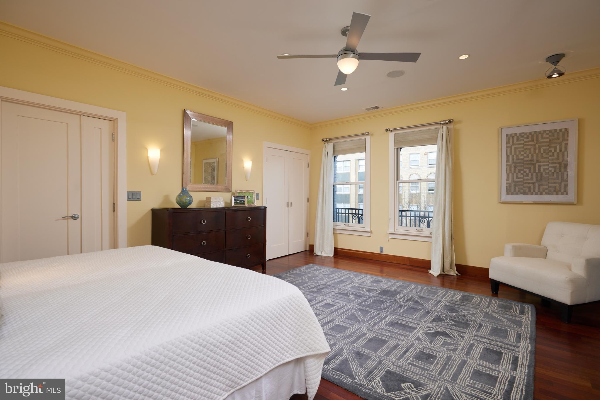2230 California Street Northwest, Unit 6AE Washington, DC 20008 - Photo 13 of 45 a large bedroom with a bed and a chandelier