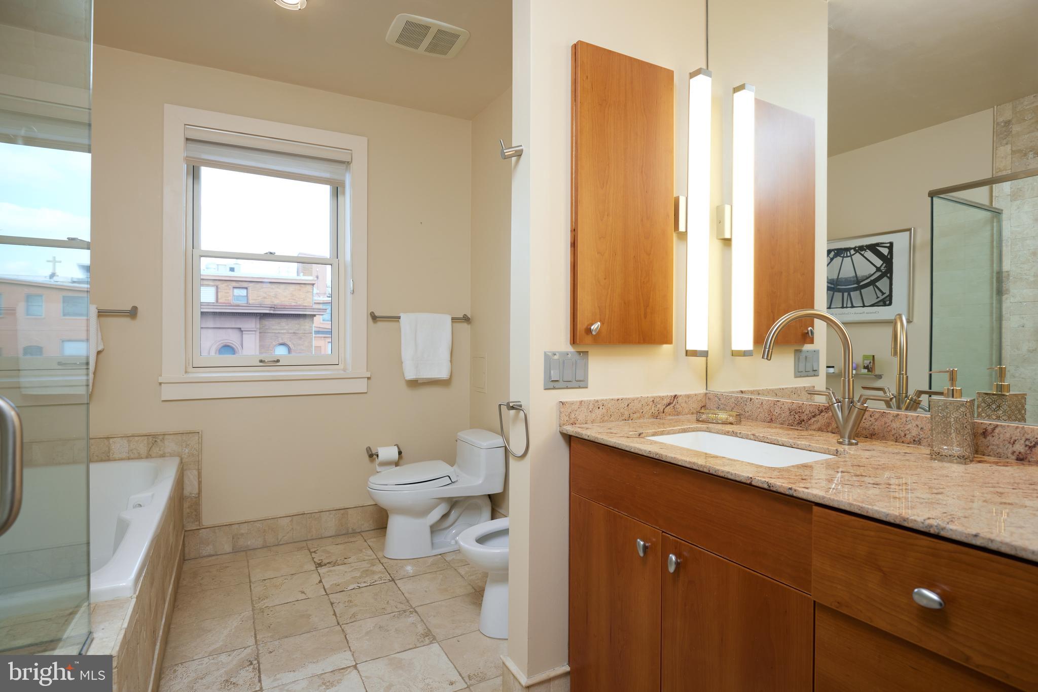 2230 California Street Northwest, Unit 6AE Washington, DC 20008 - Photo 16 of 45 a bathroom with a granite countertop sink toilet and mirror