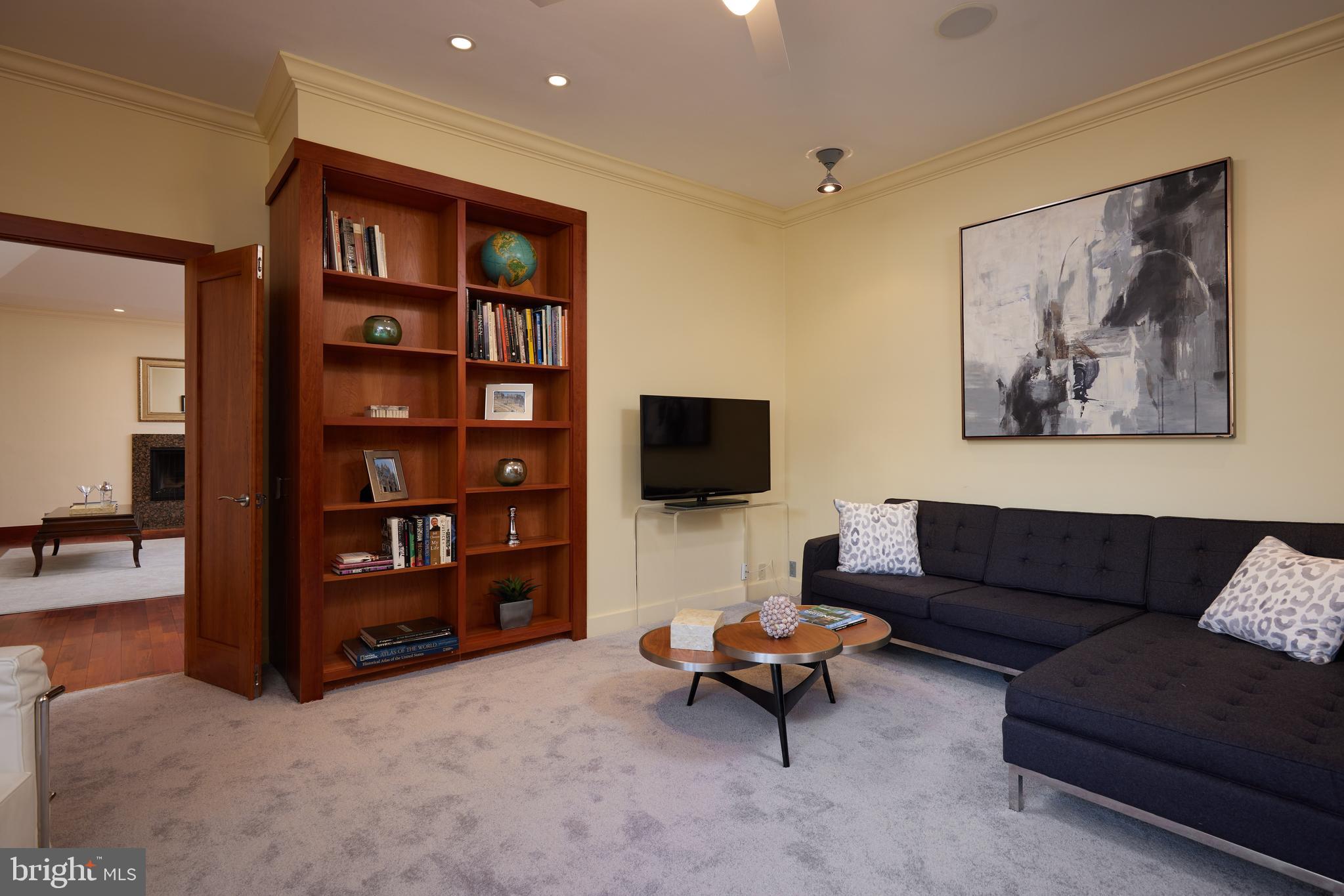 2230 California Street Northwest, Unit 6AE Washington, DC 20008 - Photo 21 of 45 a living room with furniture and a flat screen tv