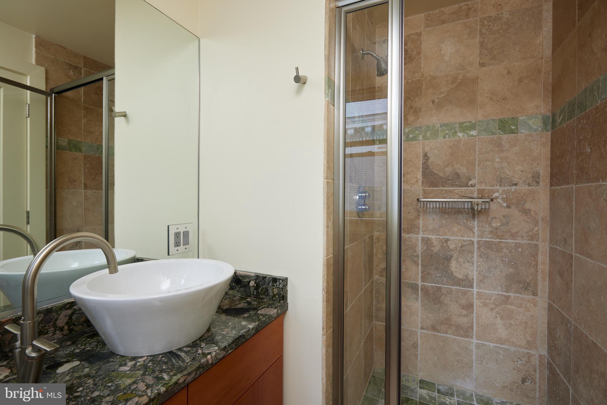 2230 California Street Northwest, Unit 6AE Washington, DC 20008 - Photo 23 of 45 a bathroom with a granite countertop sink and a mirror