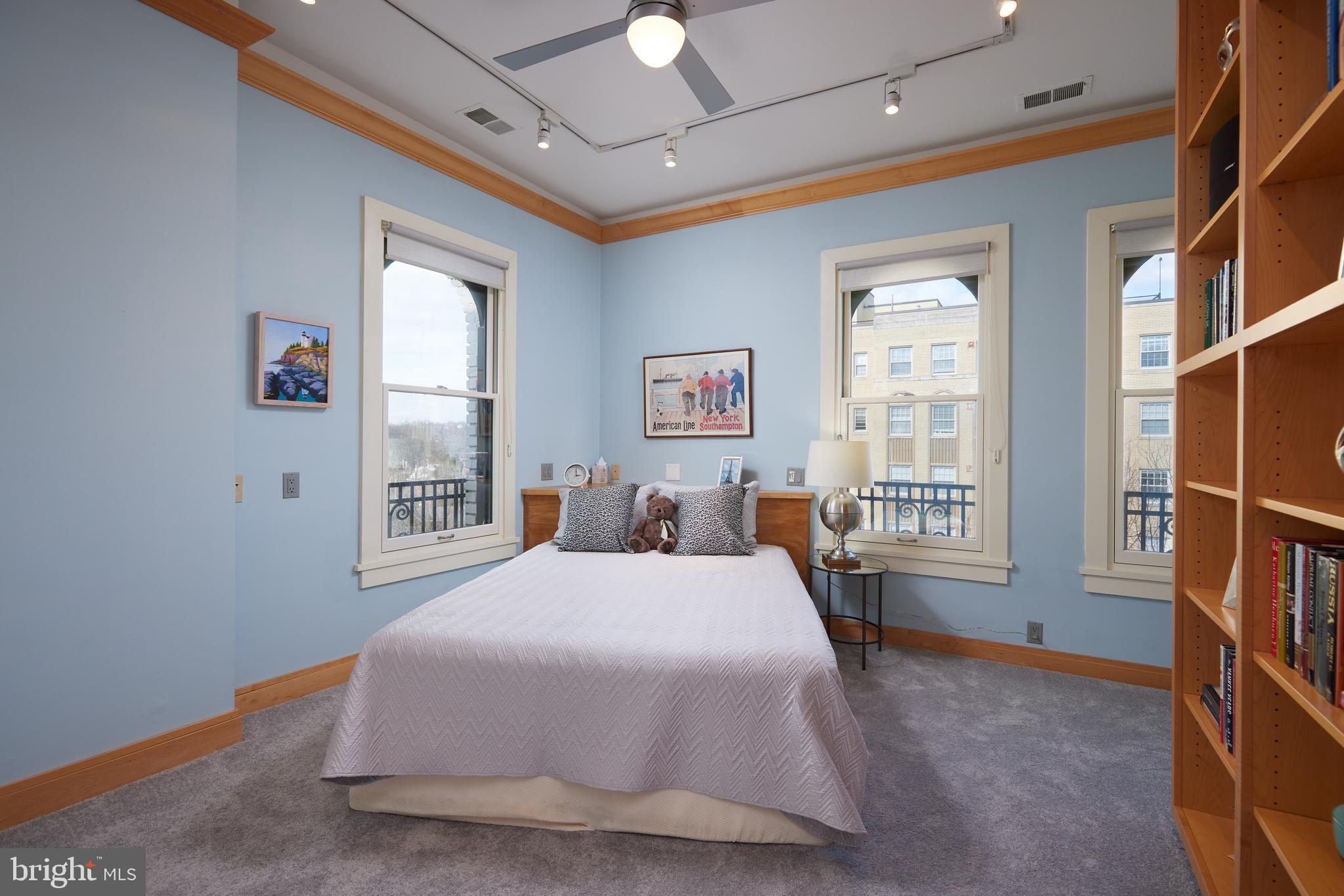 2230 California Street Northwest, Unit 6AE Washington, DC 20008 - Photo 24 of 45 a bedroom with a bed chandelier and a window