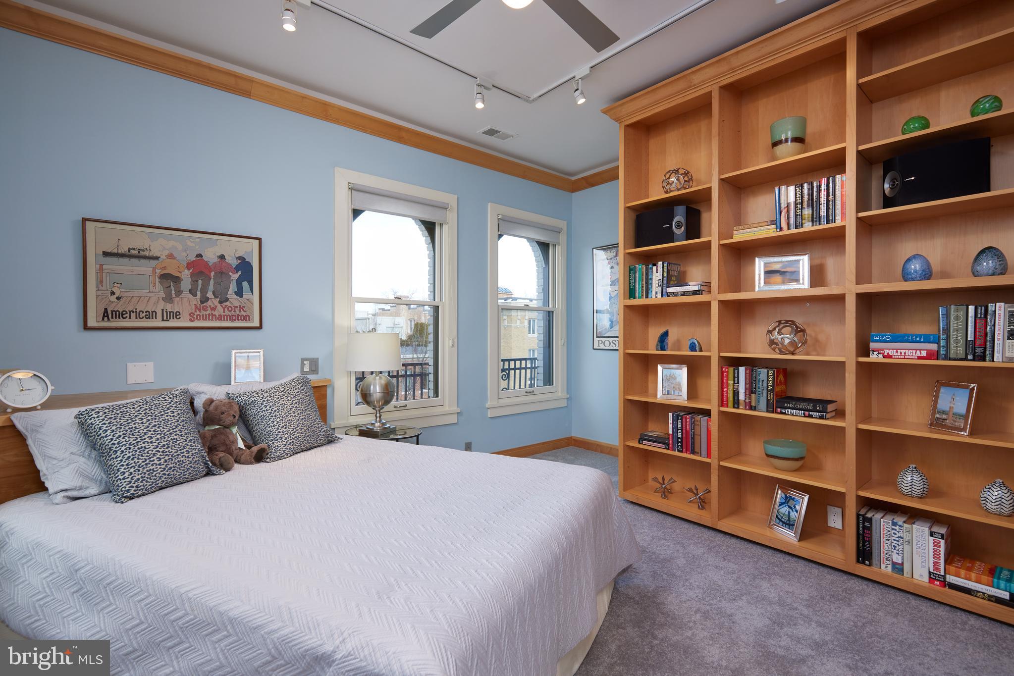 2230 California Street Northwest, Unit 6AE Washington, DC 20008 - Photo 25 of 45 a bedroom with a large bed and a book shelf