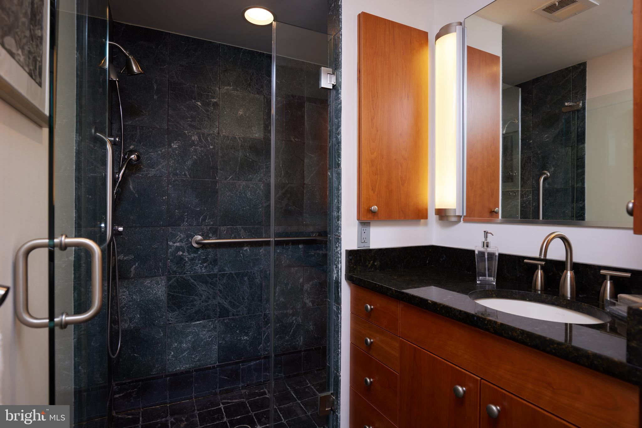 2230 California Street Northwest, Unit 6AE Washington, DC 20008 - Photo 26 of 45 a bathroom with a granite countertop sink and a mirror