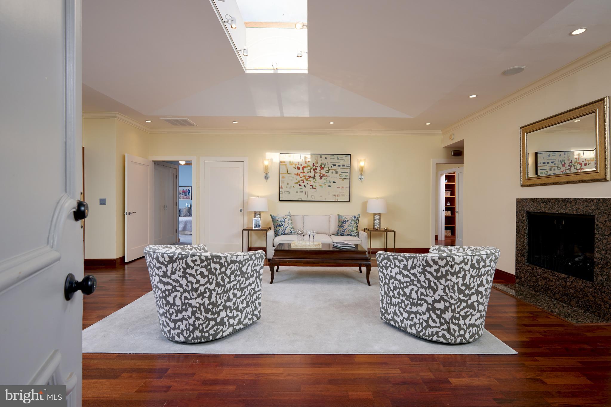 2230 California Street Northwest, Unit 6AE Washington, DC 20008 - Photo 4 of 45 a living room with furniture a fireplace and a large window