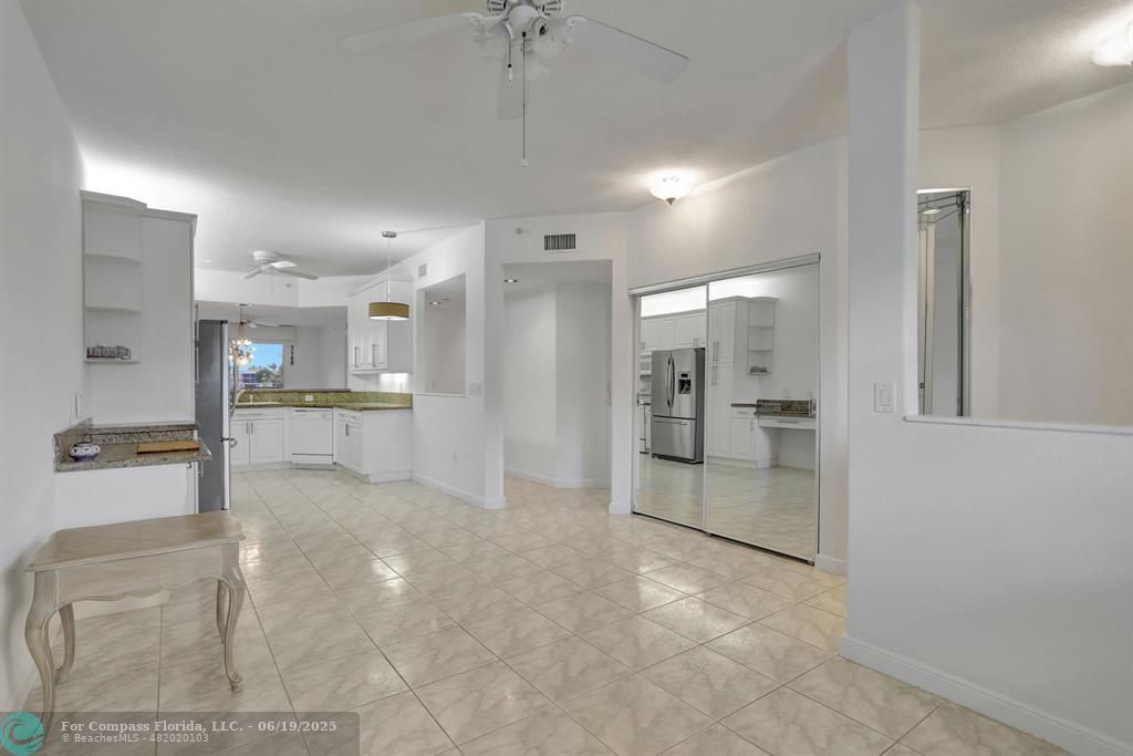 a view of a kitchen with a refrigerator and a sink
