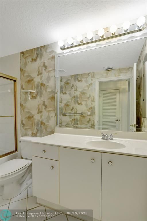 7727 Southampton Terrace, Unit 205 Tamarac, FL 33321 - Photo 13 of 36 a bathroom with a granite countertop sink a toilet and shower